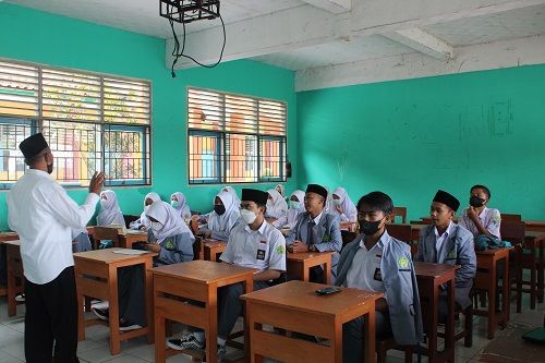 man teacher teaching in front of students